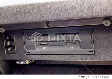Modern navigation system with memory cards in the glove box of a car, close-up Modern navigation system with memory cards in the glove box of a car, close-up 95274508