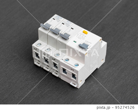 Electrical circuit breakers on a gray background, close-up. Designed for switching electrical circuits and their protection. 95274526