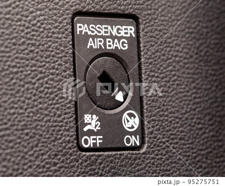 The switch on the panel of the car turns on and off the passenger airbag, macro The switch on the panel of the car turns on and off the passenger airbag, macro 95275751