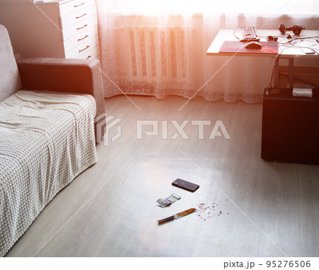 The scene of the crime in the room of the apartment. Knife in blood, money dollars and smarfton lie on the floor. Robbery and theft, crime, evidence The scene of the crime in the room of the apartment. Knife in blood, money dollars and smarfton lie on the floor. Robbery and theft, crime, evidence 95276506
