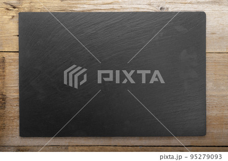 Empty cutting slate board on planks food background concept. Empty cutting slate board on planks food background concept. 95279093