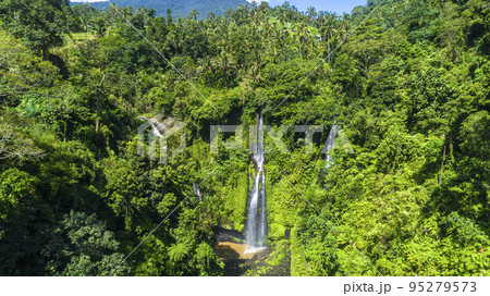 Beautiful tropical waterfall Bali Indonesia in forest at sunny day aerial view 95279573