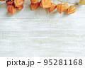 Autumn composition.Physalis border on wooden background. Flat lay 95281168