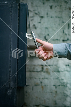 Metal door handle for fireplace close up, metal stone for heating. 95281828