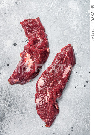 Machete steak raw cut or hanging tender cut. Gray background. Top view Machete steak raw cut or hanging tender cut. Gray background. Top view 95282949
