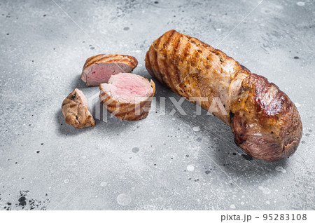 BBQ roasted pork tenderloin fillet meat. Gray background. Top view. Copy space 95283108