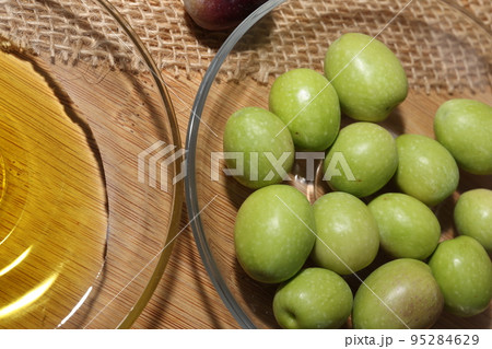 Olives and Olive Oil on wooden background 95284629
