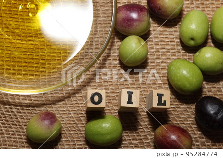Olives and Olive Oil on wooden background Olives and Olive Oil on wooden background 95284774