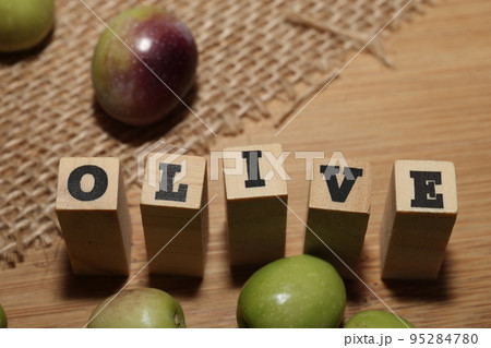 Olives and Olive Oil on wooden background Olives and Olive Oil on wooden background 95284780