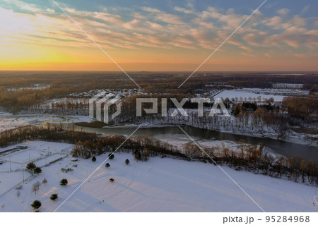 American town home complex near small river residential streets after snowfall in snowy winter landscape American town home complex near small river residential streets after snowfall in snowy winter landscape 95284968