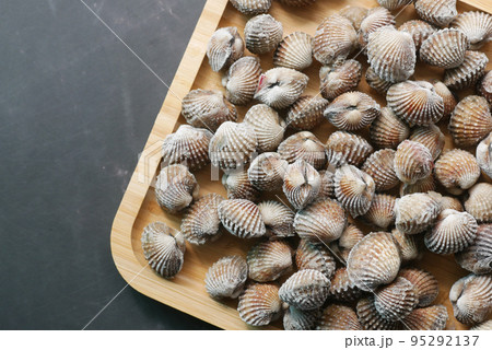 top view of cockles on a plate on black background top view of cockles on a plate on black background 95292137
