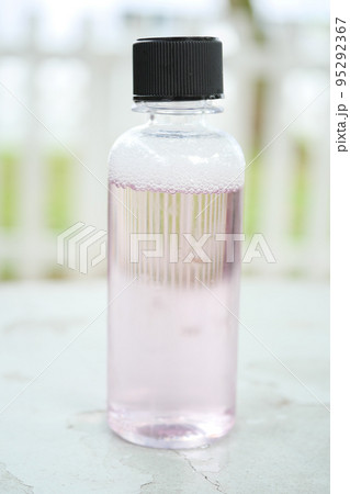 mouthwash liquid in a container on table mouthwash liquid in a container on table 95292367