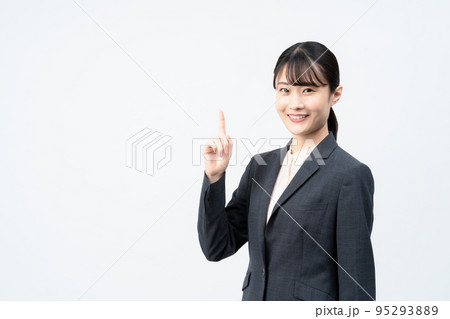 スーツの若い女性(白バック、指さしポーズ) スーツの若い女性(白バック、指さしポーズ) 95293889