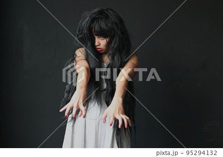 Happy Halloween day in Scary ghost woman. Asian ghost or zombie horror creepy scary have hair covering face and eye reach arm out at abandoned house dark room.  95294132