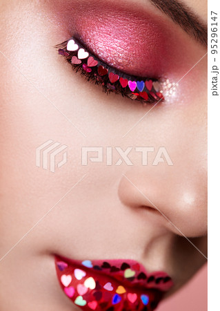 Face of beautiful woman with holiday makeup heart 95296147