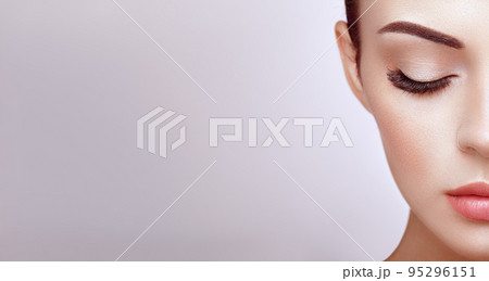 Female eye with long false eyelashes 95296151