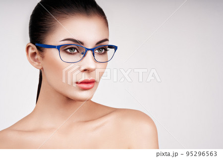Woman with long eyelashes in eyeglasses Woman with long eyelashes in eyeglasses 95296563