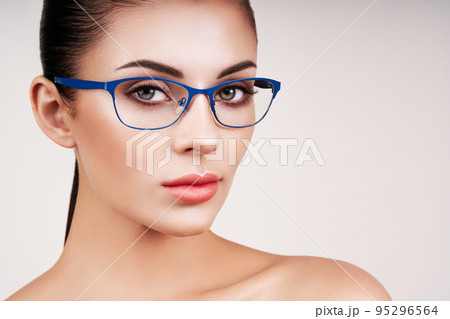 Woman with long eyelashes in eyeglasses Woman with long eyelashes in eyeglasses 95296564