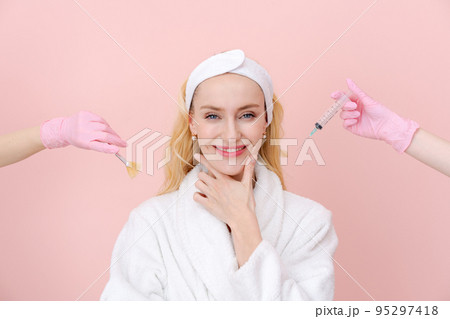 Close-up portrait thoughtful woman hands in medical gloves hold syringe 95297418