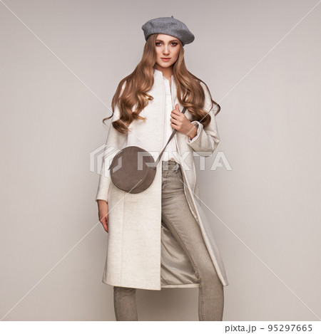 Young woman in white autumn coat Young woman in white autumn coat 95297665