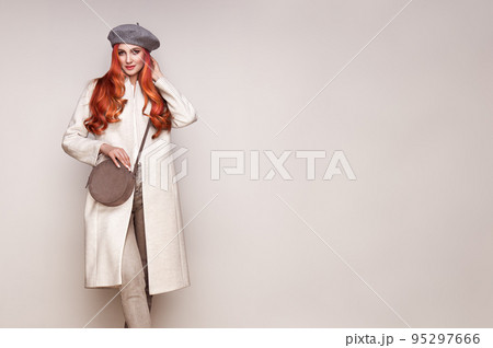 Young woman in white autumn coat 95297666