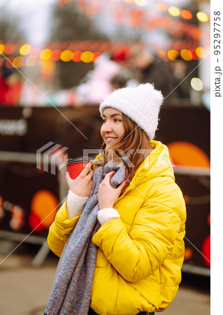 Happy woman ice skating on the ice arena in the city square on Festive Christmas fair. Cold weather. Happy woman ice skating on the ice arena in the city square on Festive Christmas fair. Cold weather. 95297758