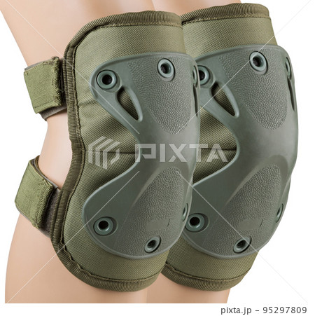 Army tactical knee pads on the legs, khaki color, close-up, on a white background, isolate Army tactical knee pads on the legs, khaki color, close-up, on a white background, isolate 95297809