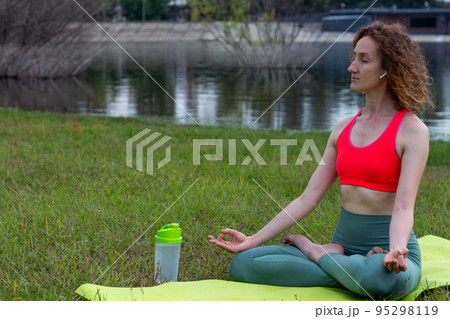 Yoga in the park serenity and relaxation 95298119