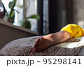 Bare feet in the bed in early morning in the sun 95298141