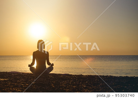 Silhouette young woman practicing yoga on the beach at sunset, Karon Beach ,Phuket ,Thailand. For 95303740