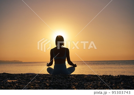 Silhouette young woman practicing yoga on the beach at sunset, Karon Beach ,Phuket ,Thailand. For 95303743