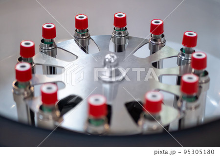 Vials with red caps in centrifuge rotor - laboratory equipment 95305180