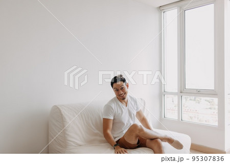 Single man playing with his sugarglider pet alone in his apartment. Single man playing with his sugarglider pet alone in his apartment. 95307836