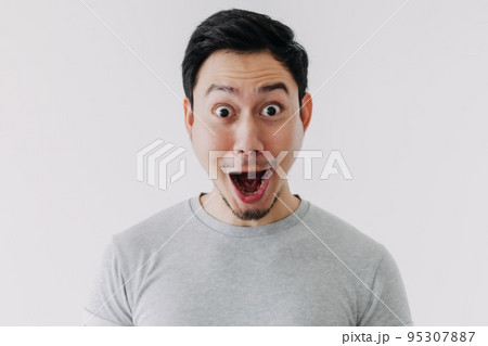Funny shocked surprised closeup face man isolated on white background. Funny shocked surprised closeup face man isolated on white background. 95307887