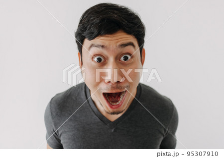 Funny surprised shocked asian man face see promotion isolated on background. 95307910