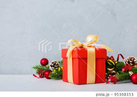 New Year Christmas mood, gift box, branches of a christmas tree, New Year decorations on a colored background New Year Christmas mood, gift box, branches of a christmas tree, New Year decorations on a colored background 95308353