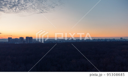 Aerial dark city and forest, epic sunset evening 95308685