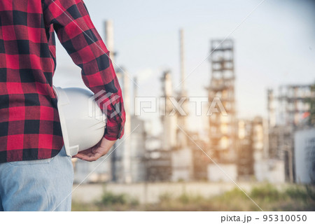 Refinery woman engineer oil industry hands hold worker helmet hard hat. Refinery industry engineering. Engineer woman hands holding hardhat white work helmet hard hat for Construction Engineering Refinery woman engineer oil industry hands hold worker helmet hard hat. Refinery industry engineering. Engineer woman hands holding hardhat white work helmet hard hat for Construction Engineering 95310050