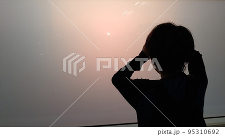 磨りガラス越しの夕日を見つめる少年 磨りガラス越しの夕日を見つめる少年 95310692