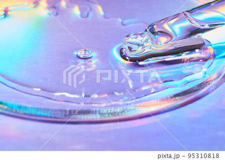 Pipette with sample of cosmetic product in petri dish on holographic background, iridescent highlights, selective focus 95310818