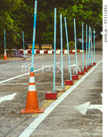 Driving test and training area with simulate test for driving license. Driving school practice traffic area with pole signs and orange cones and road signs for safety on concrete road. Selective 95311861