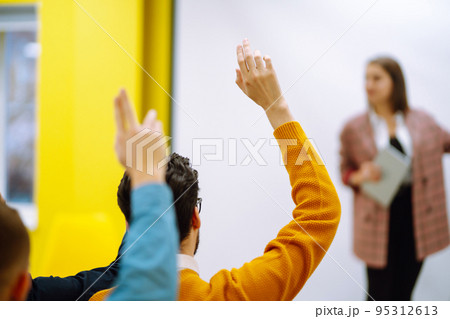 Business people raising hand up to ask question with speaker 95312613