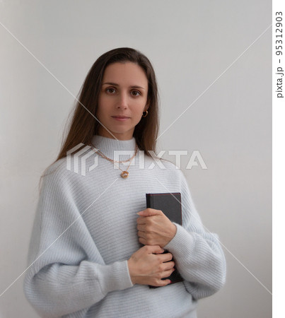 Low angle of young pretty bussines woman standing with arms crossed isolated on white background 95312903