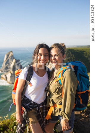 Portrait of smiling mother and daughter hiking 95313824