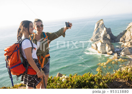 Happy mid adult woman taking selfie with daughter 95313880