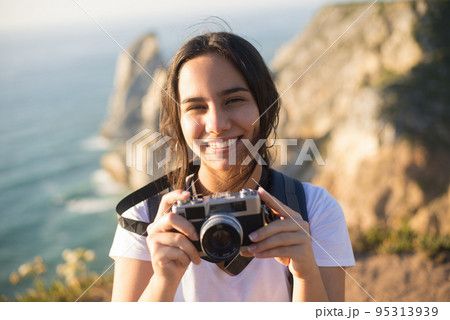 Portrait of teenage girl with camera smiling Portrait of teenage girl with camera smiling 95313939