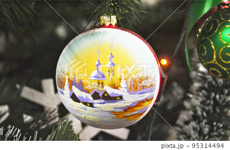 Shiny Christmas ball with pattern hanging on pine branches with festive background 95314494
