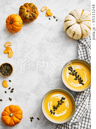 Pumpkin cream soup in a bowl with squash seeds Pumpkin cream soup in a bowl with squash seeds 95315248
