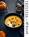 Pumpkin cream soup with croutons on dark background 95315291
