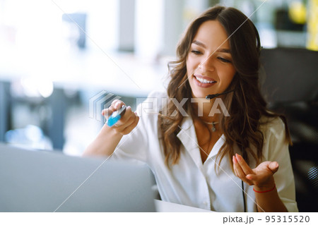 Young operator woman agent with headsets working in a call centre. Call center service. Young operator woman agent with headsets working in a call centre. Call center service. 95315520